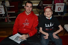Mens Basketball player Ronnie Drinnon bonds with Team IMPACT student Jorden McClure.